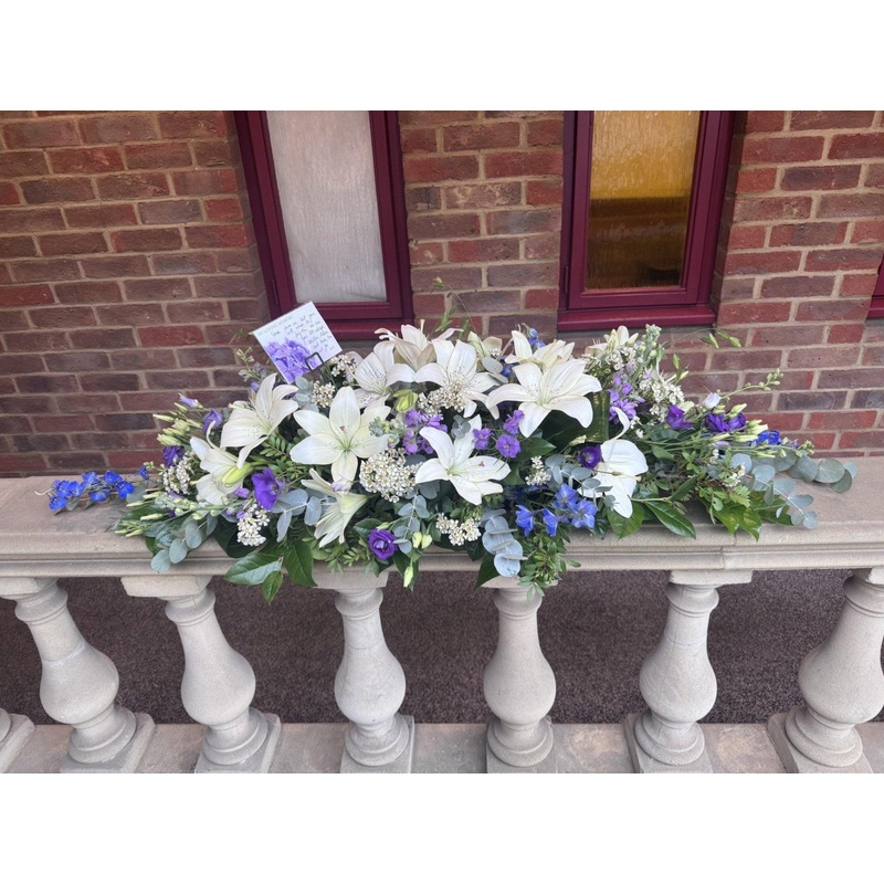 BLUE AND WHITE CASKET SPRAY-150.00 – Standard & 180.00 – Grand (As shown in image) & 210.00 – Superior-Blue and White Casket Spray & Blue and Yellow Casket Spray