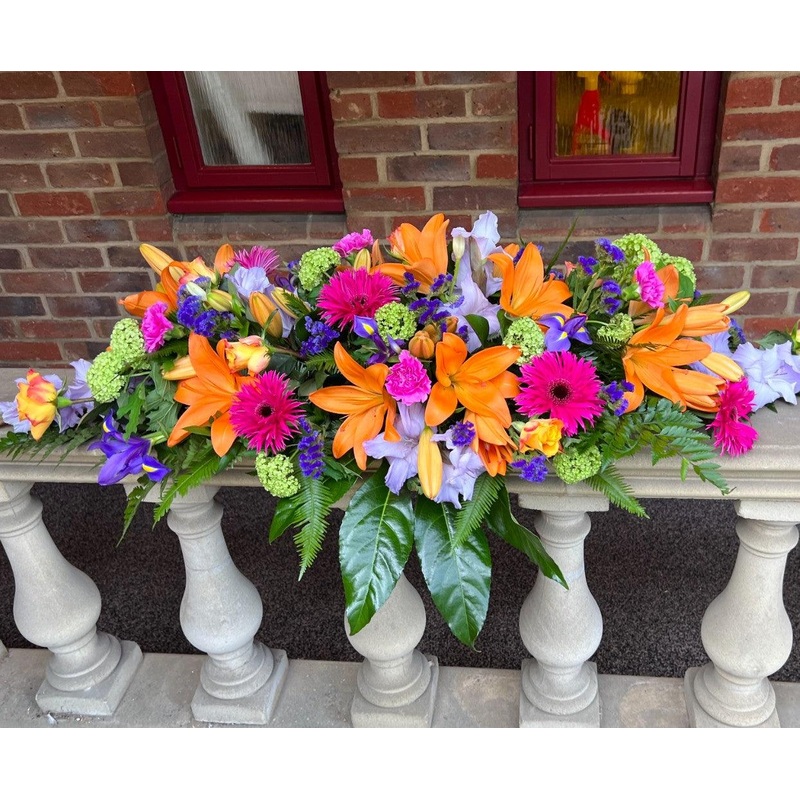 Lily Vibrant Casket Spray-128.00 – Standard & 173.00 – Grand (As shown in image) & 218.00 – Superior