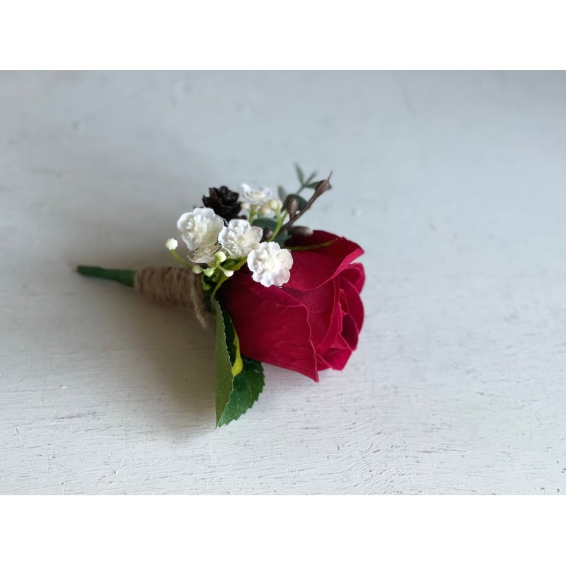 Red rose, gypsophila and pine cone wedding buttonhole