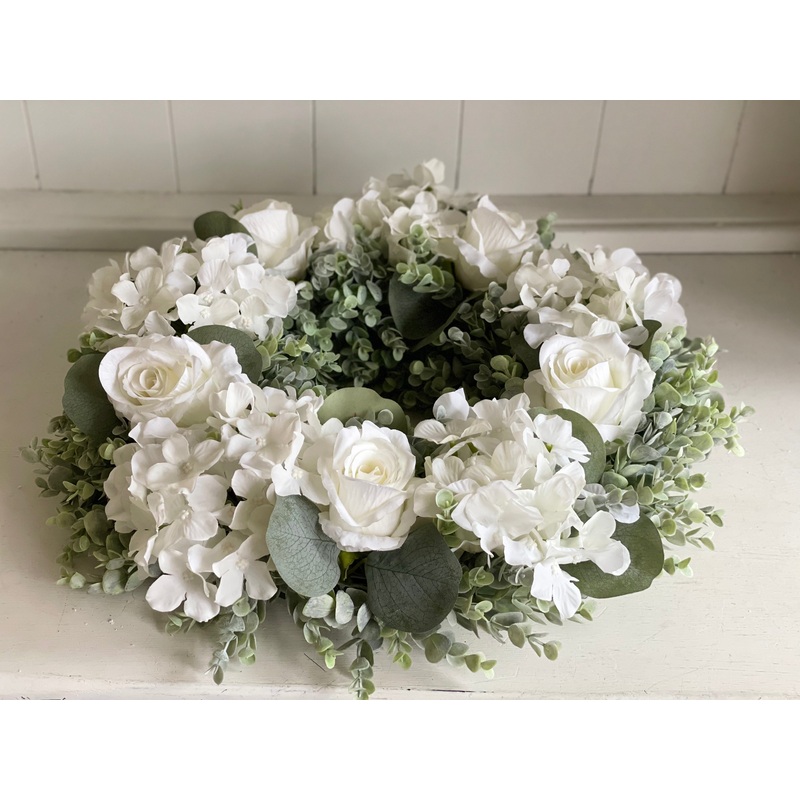 White roses and hydrangea with eucalyptus. Artificial flower wreath.