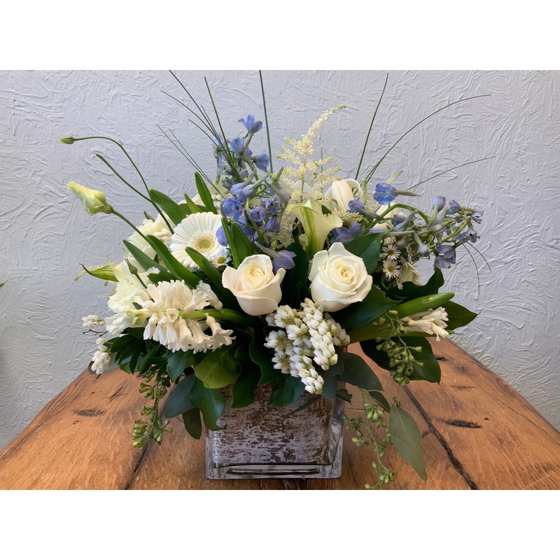 Peace & Light- Mix of White Florals with Blue Delphinium in a square glass vase